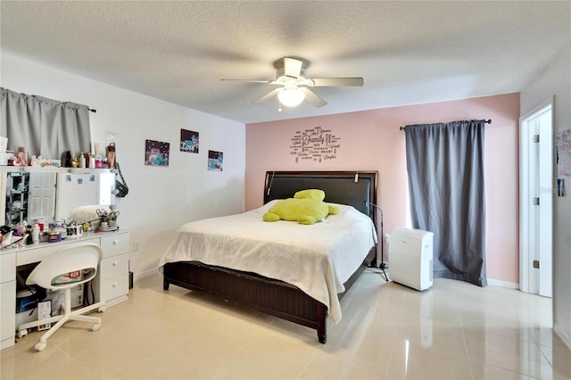 bedroom featuring baseboards, a ceiling fan, and a textured ceiling