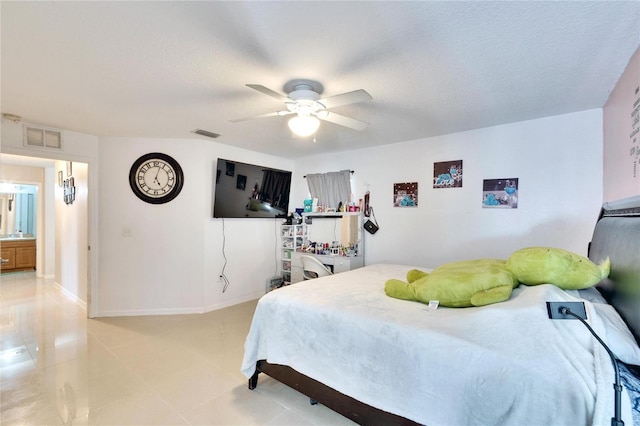 bedroom with baseboards, visible vents, ceiling fan, and a textured ceiling