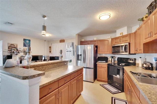 kitchen with visible vents, appliances with stainless steel finishes, light floors, pendant lighting, and a sink