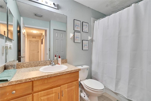 bathroom with tile patterned flooring, visible vents, vanity, and toilet