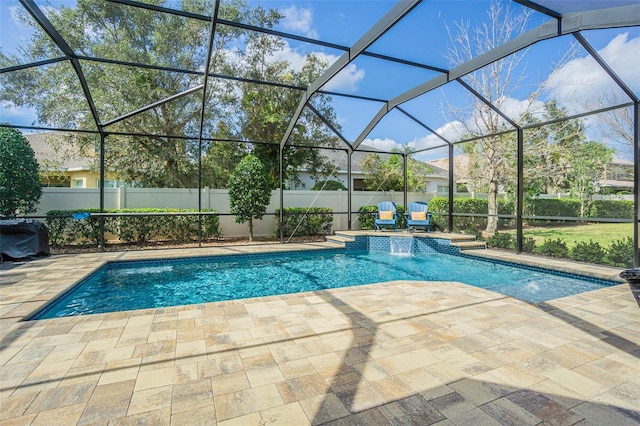 view of pool featuring a fenced in pool, glass enclosure, a patio, and a fenced backyard