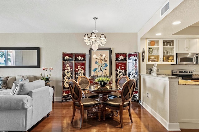 dining area with baseboards, visible vents, a chandelier, and dark wood-type flooring