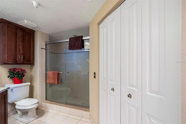 full bathroom featuring a stall shower, visible vents, and a closet