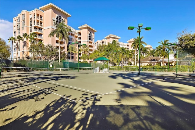 view of tennis court featuring fence