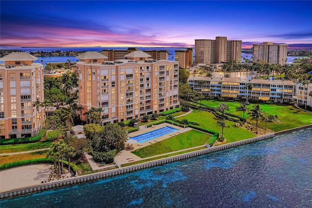 birds eye view of property with a view of city and a water view