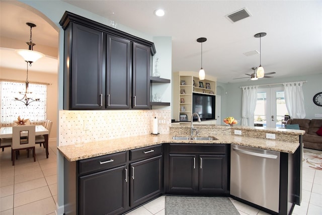 kitchen featuring sink, tasteful backsplash, decorative light fixtures, stainless steel dishwasher, and kitchen peninsula