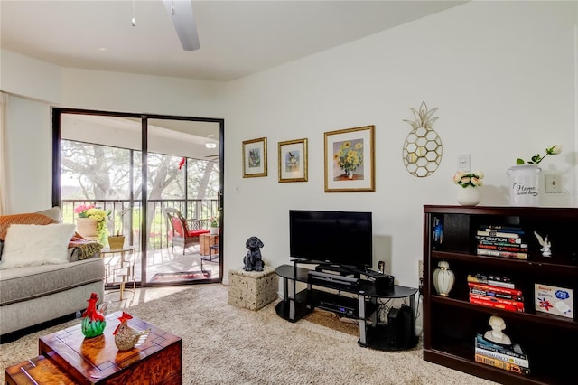 carpeted living room with ceiling fan