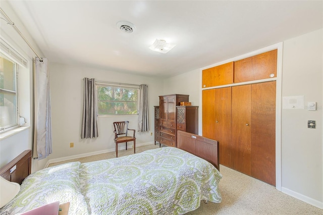 bedroom with light colored carpet and a closet