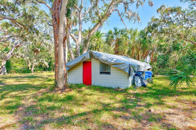 view of outbuilding with a yard