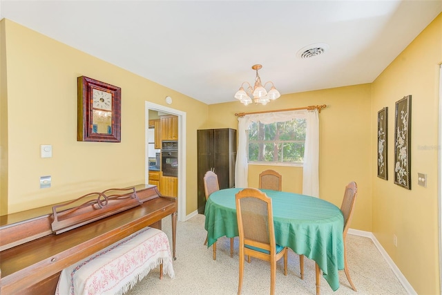 carpeted dining space with a notable chandelier