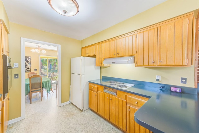 kitchen featuring white appliances and a chandelier