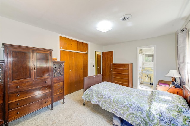 carpeted bedroom featuring connected bathroom and a closet