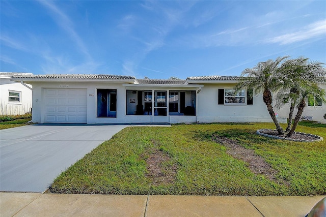 view of front of property featuring a garage and a front lawn