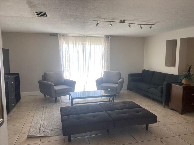 907 Fruitland Ave, Bradenton, FL 34207 - living room with track lighting, visible vents, a textured ceiling, and light tile patterned flooring