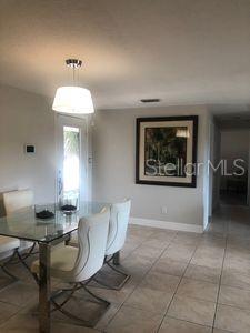 907 Fruitland Ave, Bradenton, FL 34207 - dining area featuring tile patterned flooring and baseboards