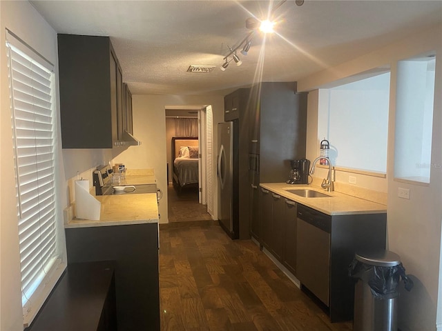 907 Fruitland Ave, Bradenton, FL 34207 - kitchen with visible vents, appliances with stainless steel finishes, dark wood-type flooring, light countertops, and a sink