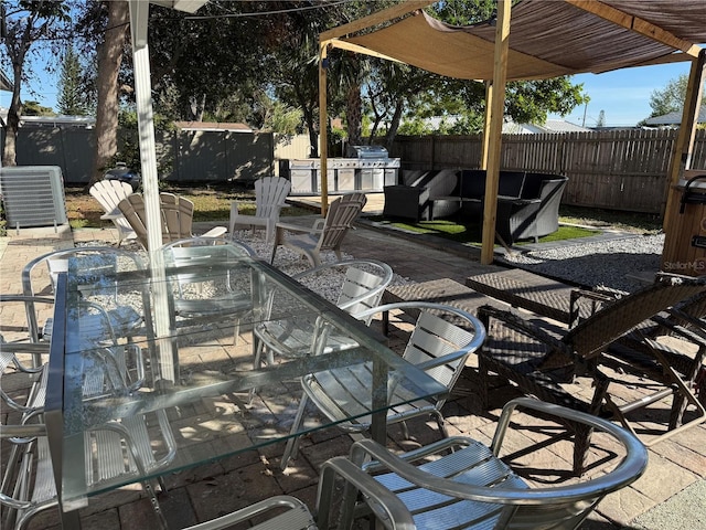 907 Fruitland Ave, Bradenton, FL 34207 - view of patio / terrace featuring central AC unit, a fenced backyard, an outdoor structure, a shed, and outdoor dining space