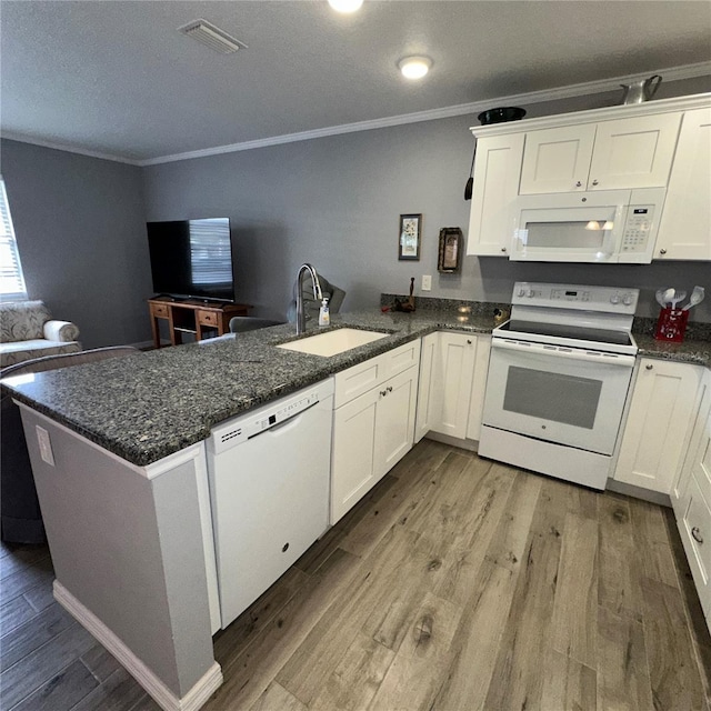 kitchen featuring sink, white appliances, light hardwood / wood-style floors, white cabinets, and kitchen peninsula