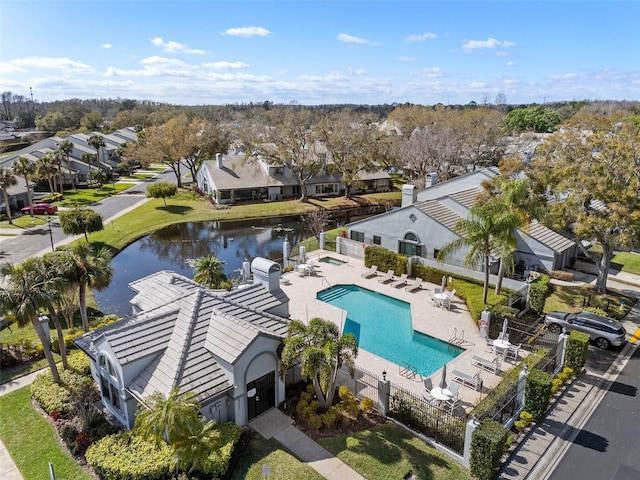 drone / aerial view featuring a water view and a residential view