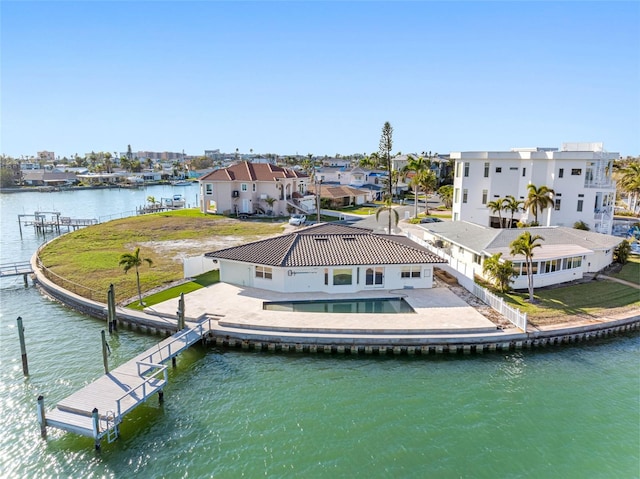 dock area with a water view, fence, a yard, a residential view, and a patio area