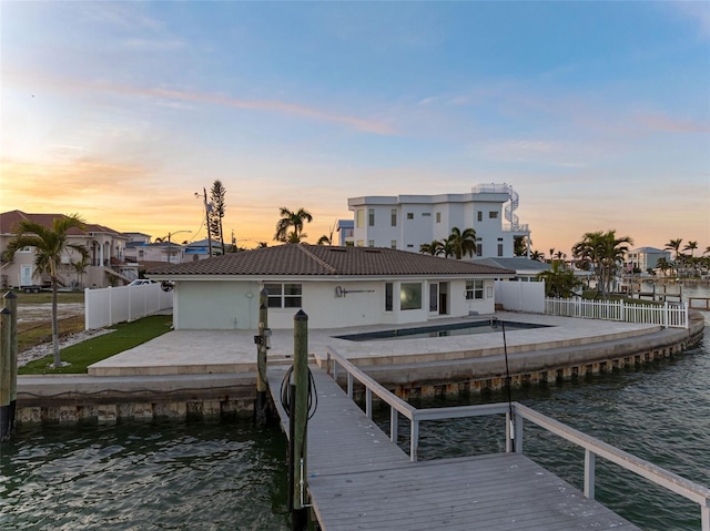 view of dock featuring a patio, a water view, a fenced backyard, and a fenced in pool