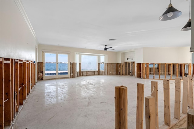 unfurnished room with a ceiling fan, a water view, crown molding, and visible vents