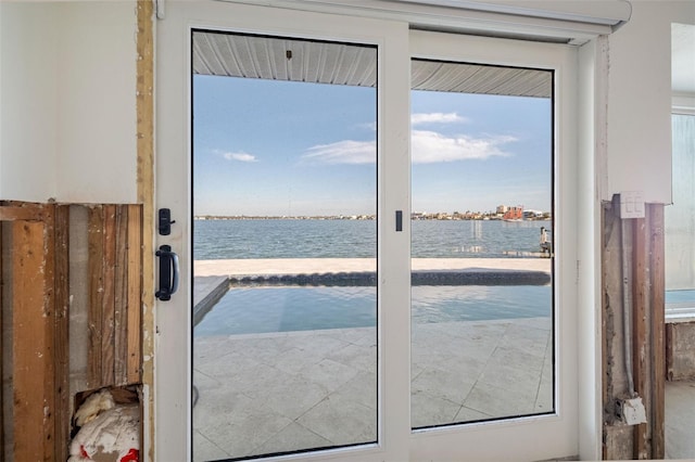 doorway to outside featuring a water view