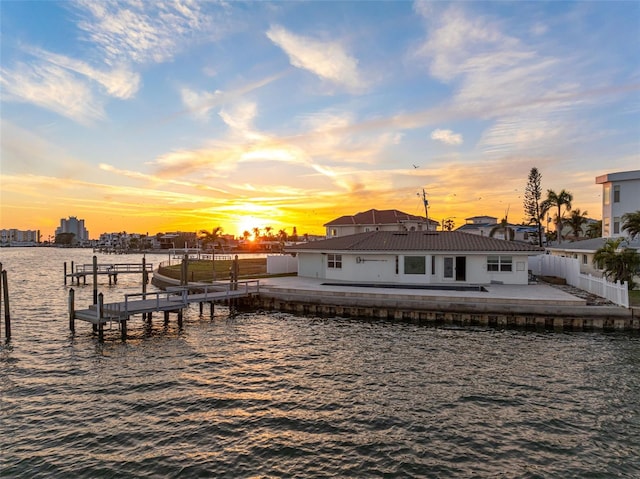 exterior space featuring a water view, a patio area, a fenced backyard, and a view of city