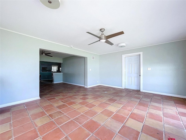 spare room featuring tile patterned flooring, a ceiling fan, and baseboards