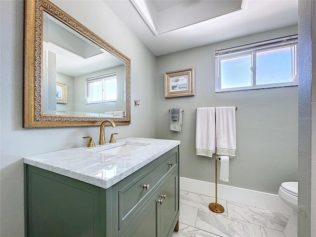 bathroom with toilet, marble finish floor, baseboards, and vanity