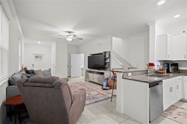 kitchen featuring open floor plan, white cabinets, dishwasher, and a sink