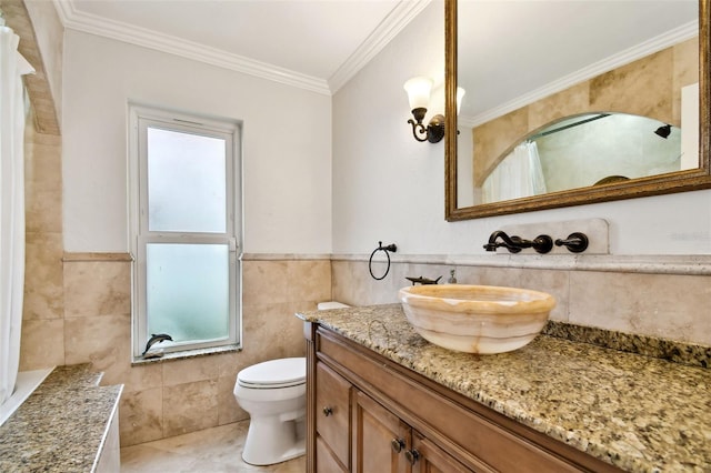 full bathroom with crown molding, tile walls, toilet, vanity, and tile patterned flooring