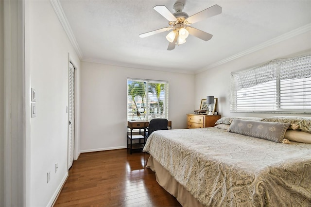 bedroom featuring a ceiling fan, baseboards, a closet, dark wood-style floors, and crown molding