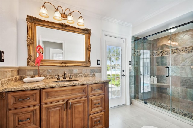 bathroom featuring ornamental molding, a stall shower, vanity, and tile walls