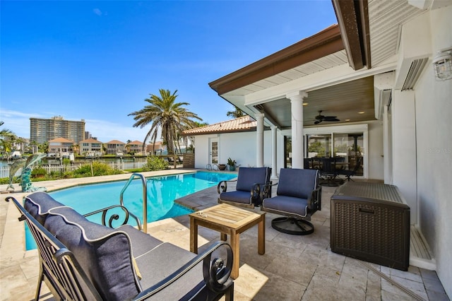 view of pool with a patio area, ceiling fan, and a fenced in pool