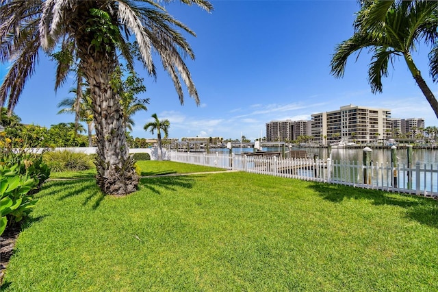 view of yard featuring a water view and fence