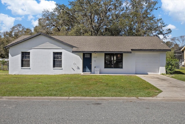 single story home with concrete driveway, a front lawn, and an attached garage