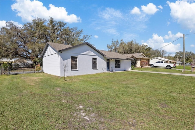 single story home with an attached garage, fence, and a front lawn