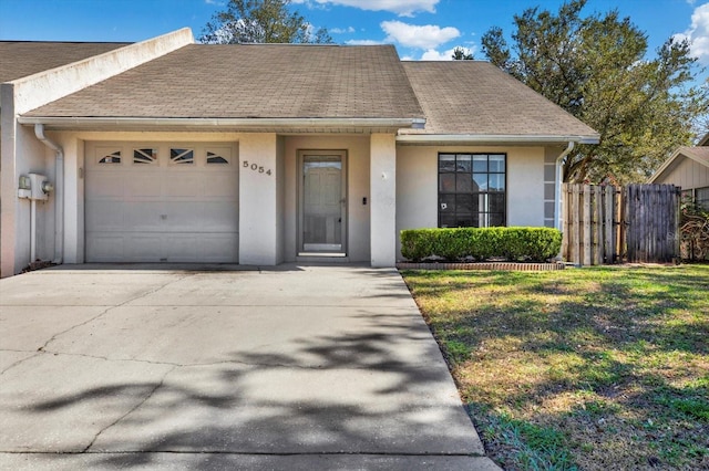 view of front of home with a garage and a front yard