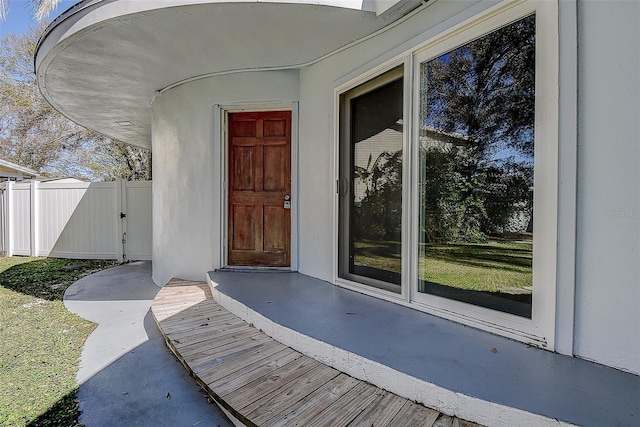 view of exterior entry featuring fence