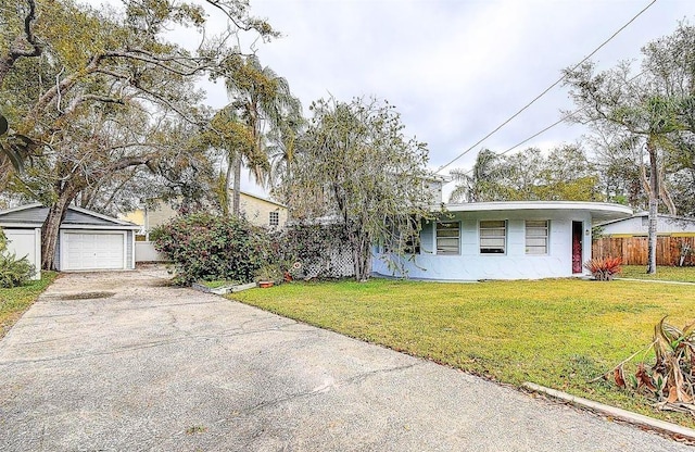 view of front facade featuring a garage, a front yard, driveway, and fence