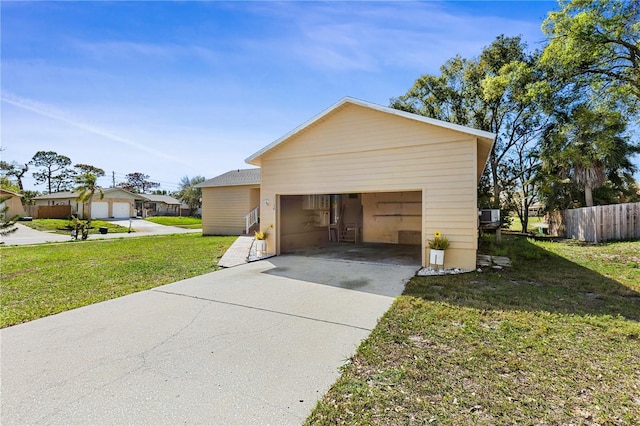 view of side of home featuring a yard and a garage