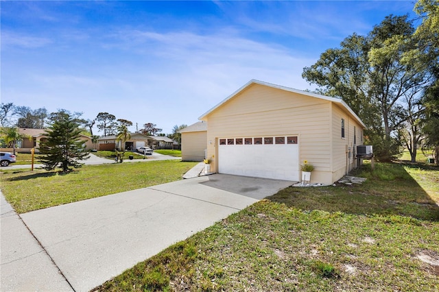 view of home's exterior with concrete driveway and a yard