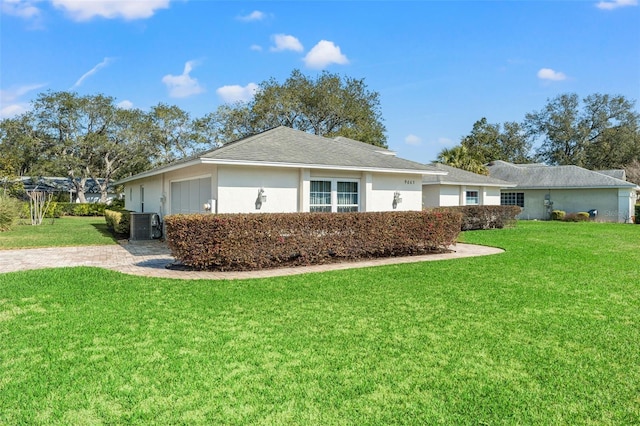 view of home's exterior with a yard and central air condition unit