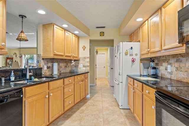 kitchen featuring decorative light fixtures, sink, dark stone counters, light tile patterned floors, and black appliances