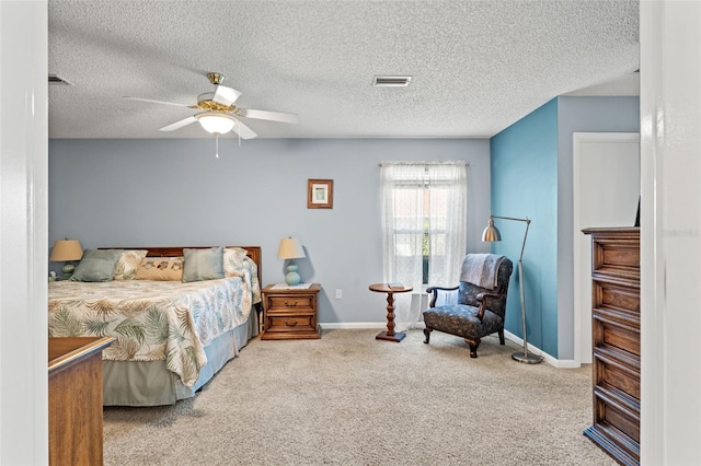 bedroom featuring light carpet, a textured ceiling, and ceiling fan