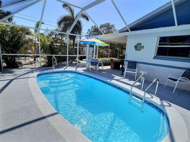 outdoor pool with a patio and a lanai