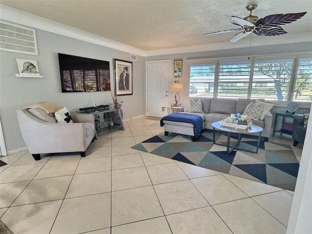 living room with a ceiling fan, tile patterned floors, a healthy amount of sunlight, and visible vents