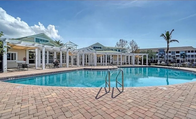 view of pool with a patio and a pergola