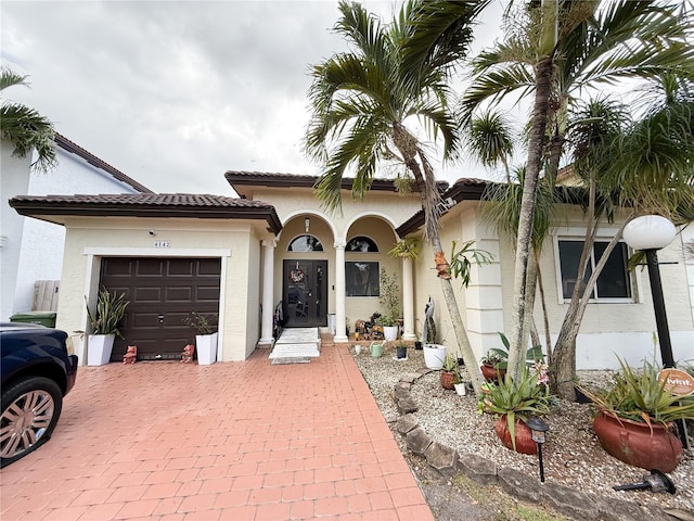 mediterranean / spanish house featuring a garage